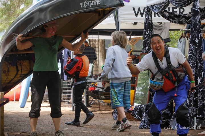 a group of people standing next to an umbrella