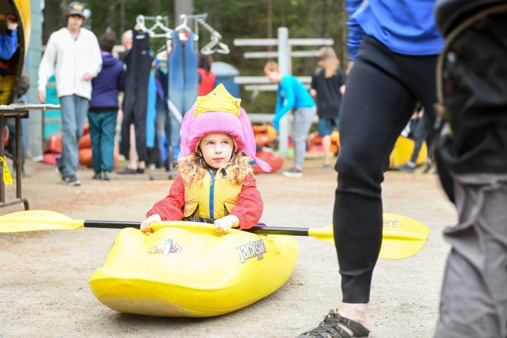 kid practicing kayaking on land