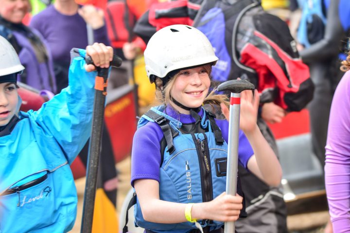 kids in kayaking gear receiving instruction
