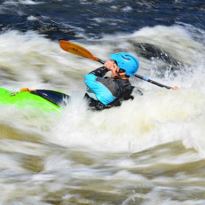 man going down a huge whitewater river