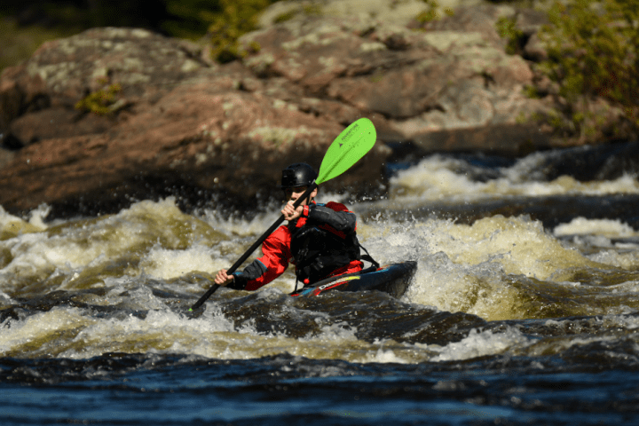 a man riding a wave on a surf board on a body of water