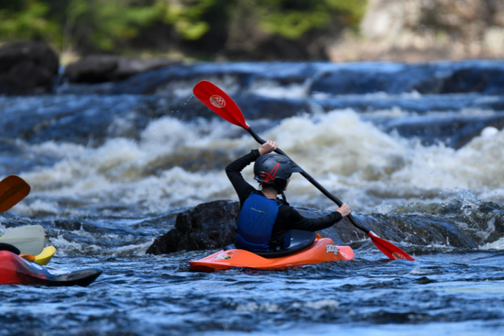 a group of people riding skis on a body of water