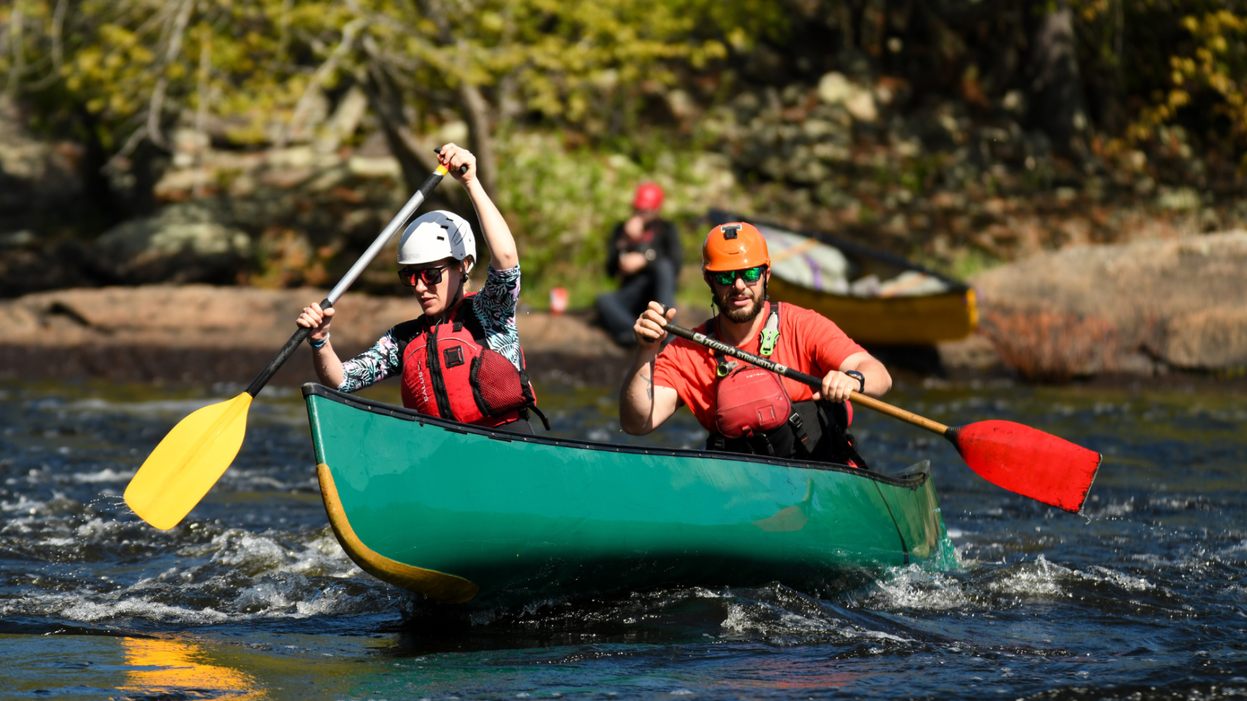two people doing a whitewater tandem canoe course