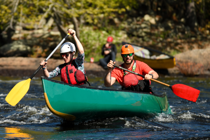 two people doing a whitewater tandem canoe course