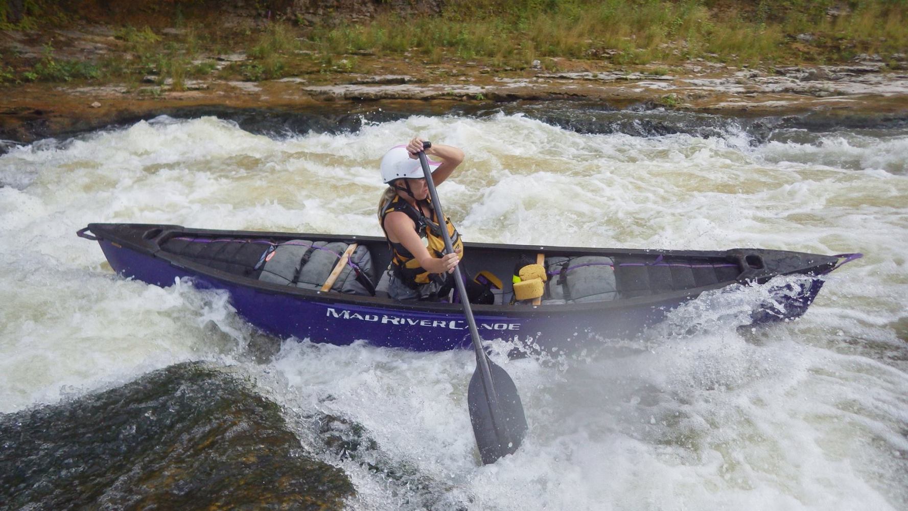 a person riding a wave on a raft in a body of water