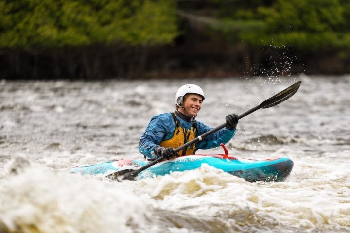 a person riding a surf board on a body of water