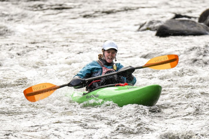 a person riding a surf board on a body of water