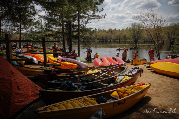 a boat that is sitting on the side of a river