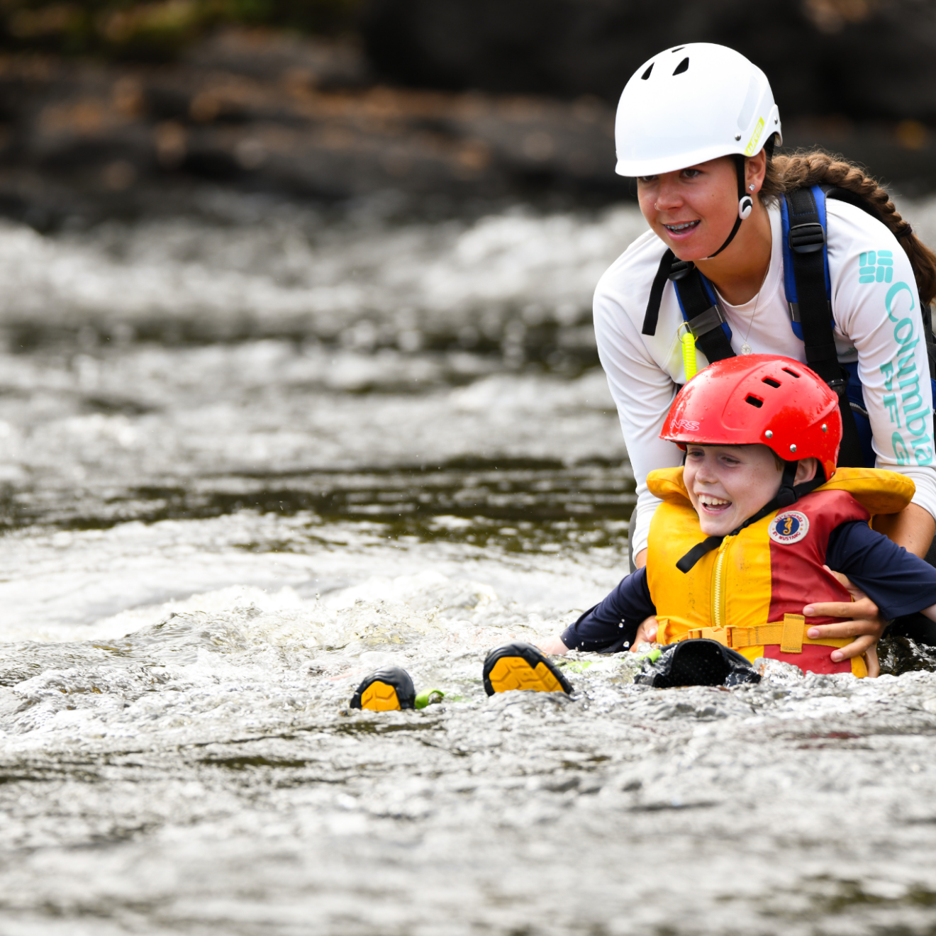 a young boy riding a boogie board in the water