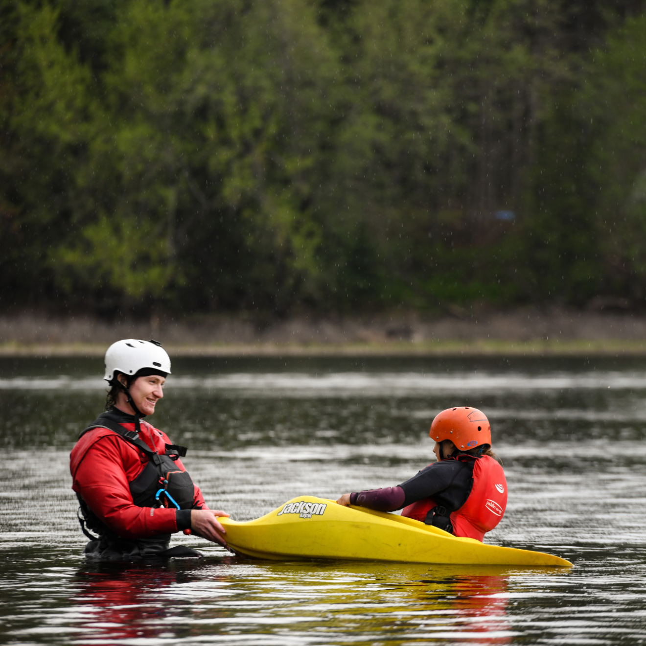 a man riding on the back of a boat in the water