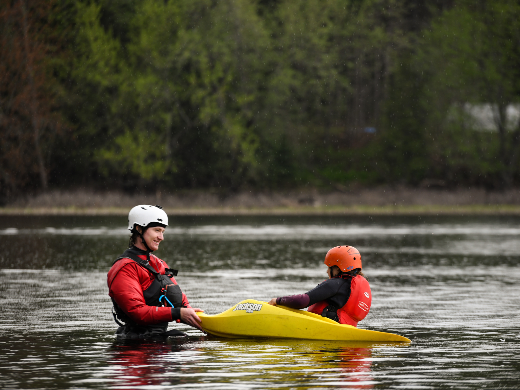 a man riding on the back of a boat in the water