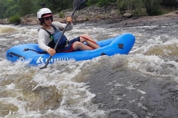 a man lying on a raft in a body of water