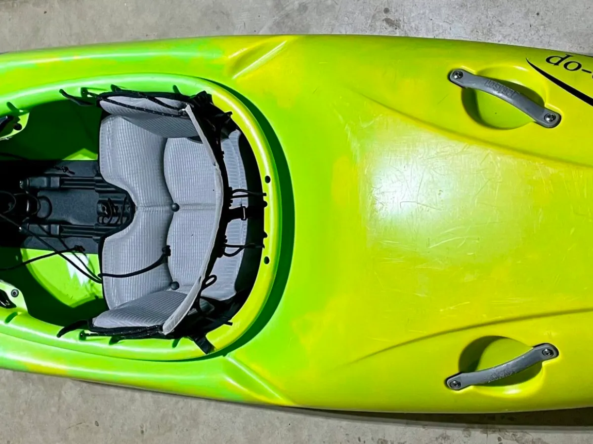 a piece of luggage sitting on top of a green car