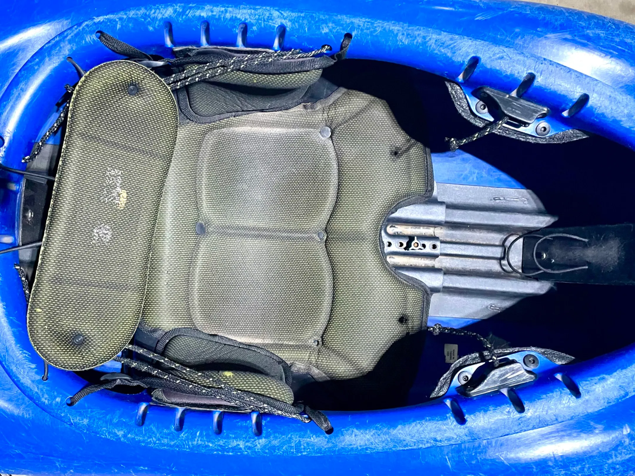a bag of luggage sitting on top of a blue suitcase