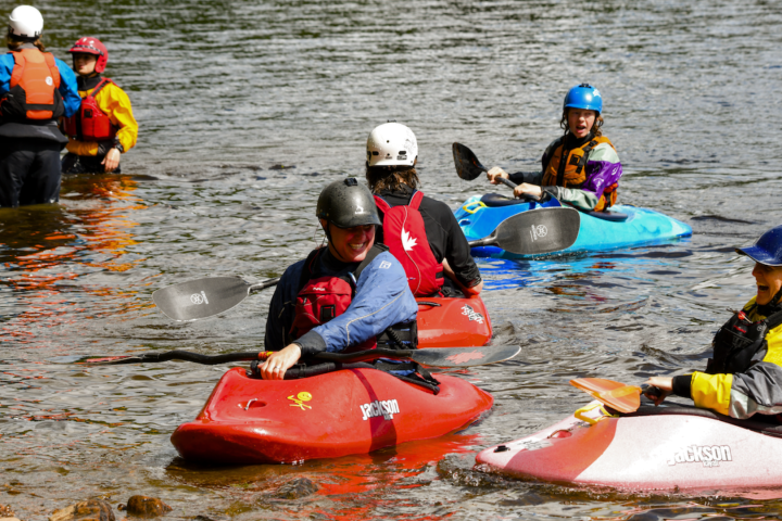 a group of people riding on a raft in the water